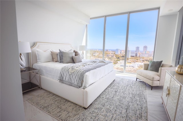 bedroom with multiple windows and a wall of windows