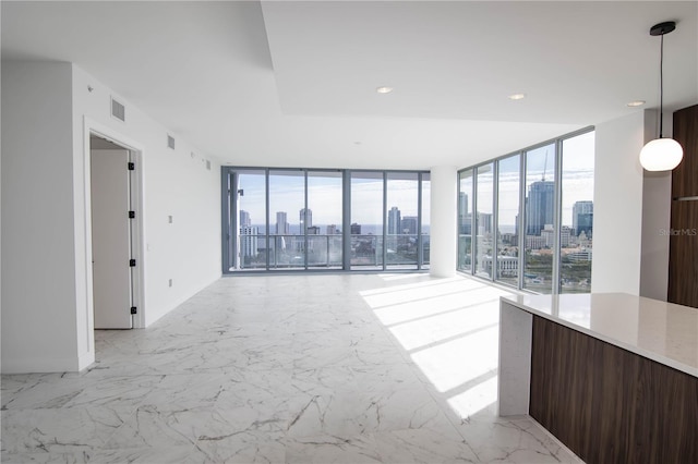 unfurnished living room with a wall of windows