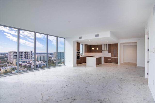 unfurnished living room with expansive windows