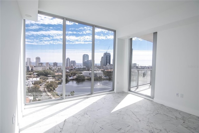 empty room with expansive windows and a water view