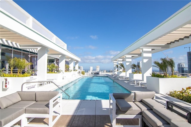 view of swimming pool featuring a patio and an outdoor living space