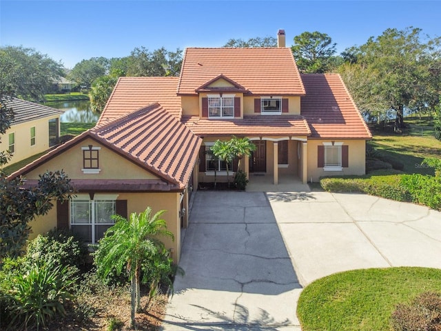 view of front of property with a water view