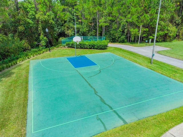 view of basketball court featuring a yard