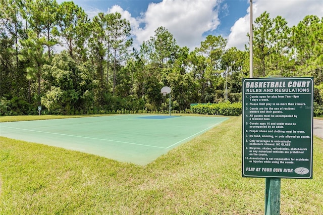 surrounding community featuring a yard and basketball court