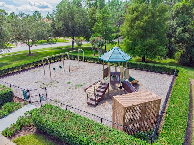 view of property's community with a yard and a playground