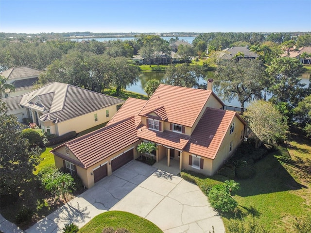 birds eye view of property with a water view