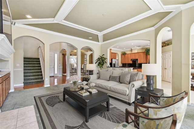 living room with light tile patterned floors and ornamental molding