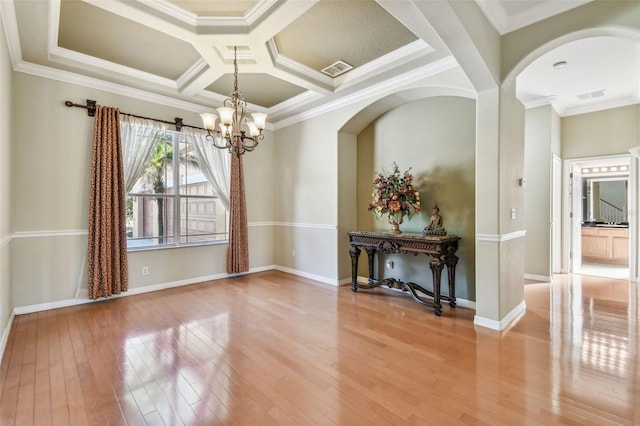 unfurnished dining area featuring crown molding, coffered ceiling, a notable chandelier, and light hardwood / wood-style floors