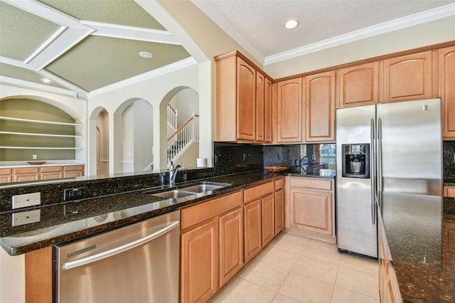 kitchen with dark stone countertops, sink, and appliances with stainless steel finishes