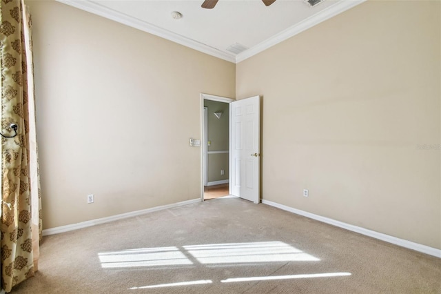 unfurnished room featuring ceiling fan, ornamental molding, and carpet flooring