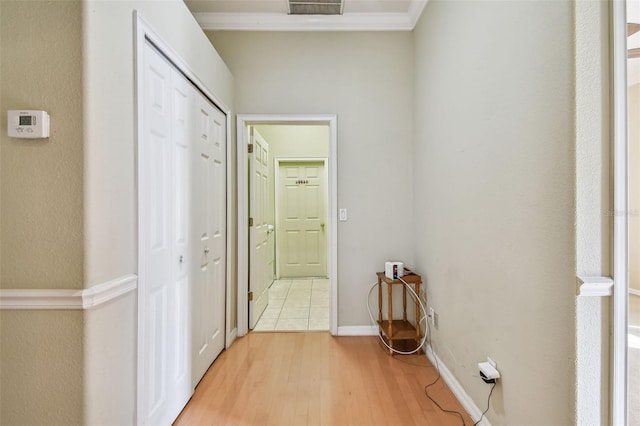 hallway featuring crown molding and hardwood / wood-style floors