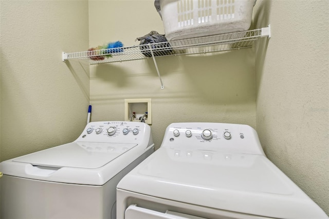 clothes washing area with washing machine and dryer