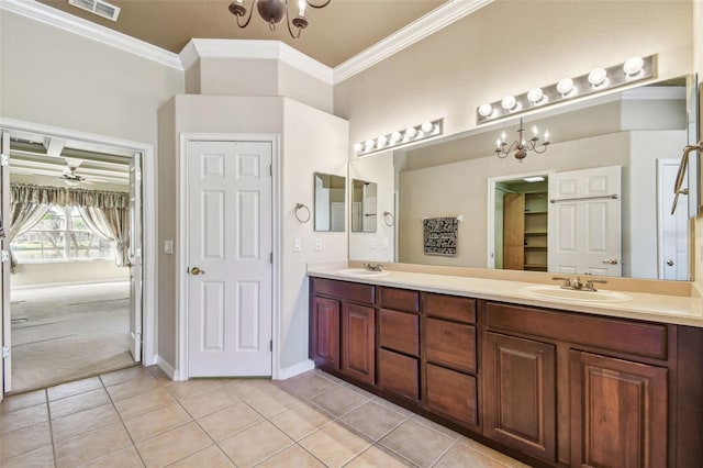 bathroom with tile patterned flooring, vanity, crown molding, and ceiling fan with notable chandelier