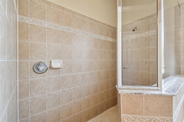 bathroom with a tile shower