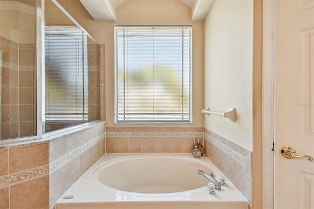 bathroom with plenty of natural light and separate shower and tub