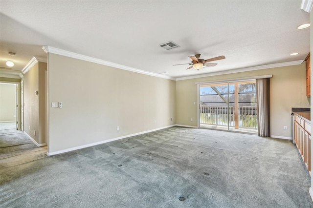 unfurnished living room with ornamental molding and carpet