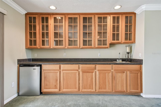 kitchen featuring sink, stainless steel fridge, light colored carpet, and ornamental molding