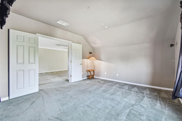 bonus room featuring vaulted ceiling and carpet