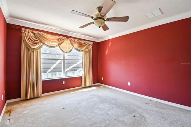 carpeted spare room featuring ornamental molding and ceiling fan