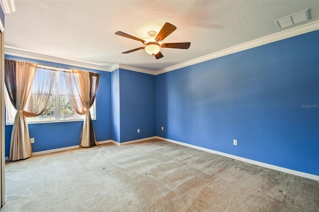 carpeted empty room featuring a textured ceiling, ornamental molding, and ceiling fan