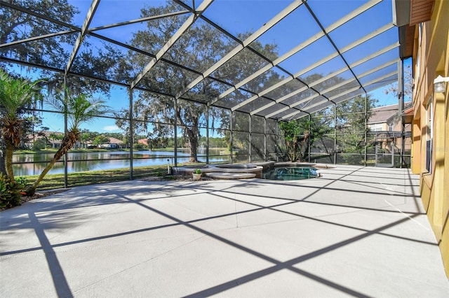 view of patio with a swimming pool with hot tub, a lanai, and a water view