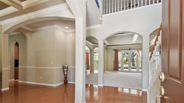 2024 Capri Ln, Mount Dora, FL 32757 - entrance foyer with arched walkways, wood finished floors, ornamental molding, coffered ceiling, and recessed lighting