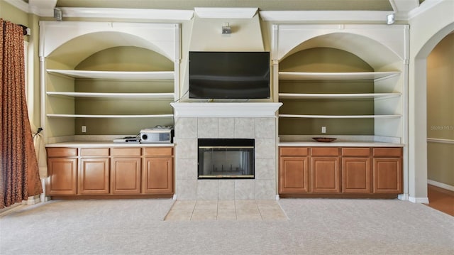 2024 Capri Ln, Mount Dora, FL 32757 - unfurnished living room with light carpet, a fireplace, and arched walkways