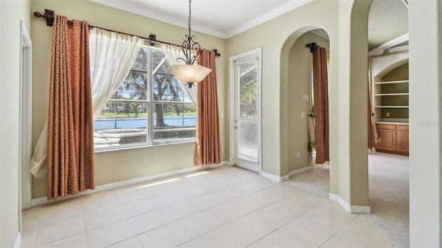 2024 Capri Ln, Mount Dora, FL 32757 - unfurnished dining area featuring arched walkways, ornamental molding, healthy amount of natural light, and light tile patterned flooring
