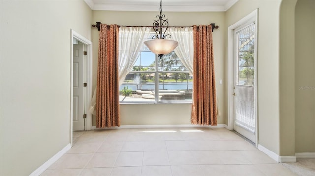 2024 Capri Ln, Mount Dora, FL 32757 - unfurnished dining area with ornamental molding, tile patterned flooring, arched walkways, and a chandelier