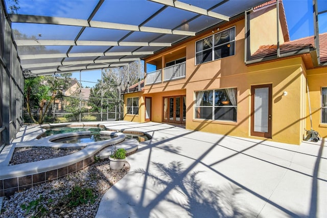 2024 Capri Ln, Mount Dora, FL 32757 - back of house featuring stucco siding, a balcony, a patio area, glass enclosure, and a pool with connected hot tub