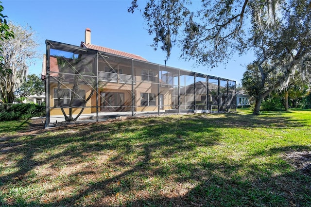 2024 Capri Ln, Mount Dora, FL 32757 - back of property with a yard, a chimney, and glass enclosure