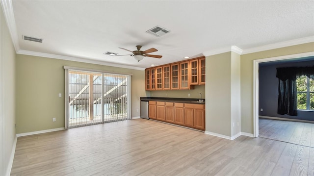 2024 Capri Ln, Mount Dora, FL 32757 - indoor wet bar featuring dishwasher, ornamental molding, light wood-type flooring, and a ceiling fan