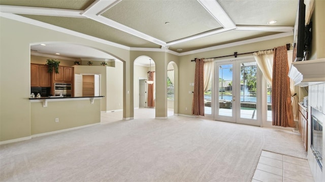 2024 Capri Ln, Mount Dora, FL 32757 - unfurnished living room with light colored carpet, arched walkways, ornamental molding, and recessed lighting