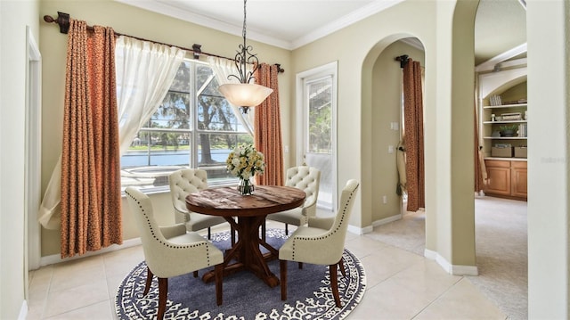 2024 Capri Ln, Mount Dora, FL 32757 - dining space featuring arched walkways, ornamental molding, light tile patterned floors, and plenty of natural light