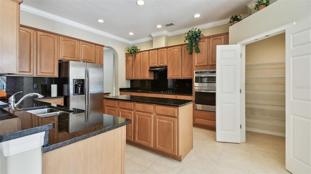 2024 Capri Ln, Mount Dora, FL 32757 - kitchen with appliances with stainless steel finishes, dark stone countertops, backsplash, ornamental molding, and light tile patterned flooring