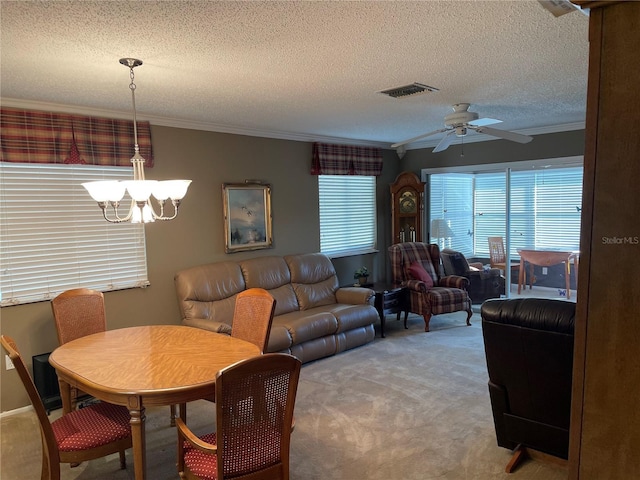 dining room featuring carpet flooring, crown molding, a textured ceiling, and ceiling fan with notable chandelier