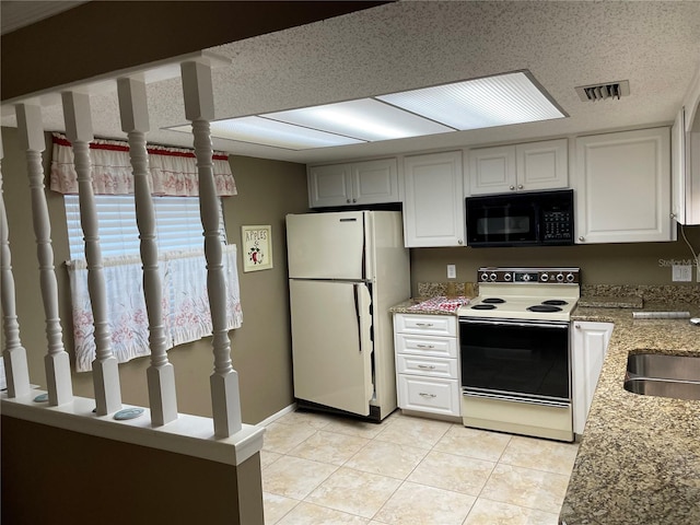 kitchen with white cabinetry, light tile patterned floors, light stone counters, and white appliances