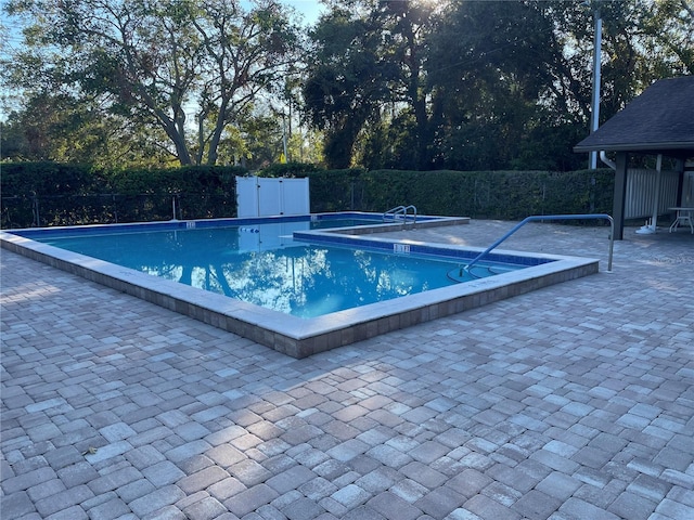 view of swimming pool featuring a patio area