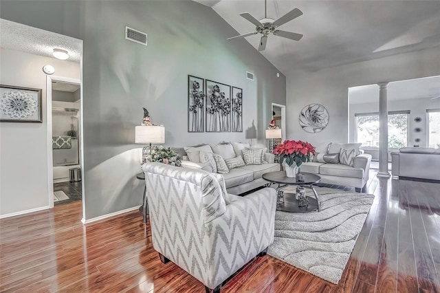 living room featuring ornate columns, ceiling fan, high vaulted ceiling, and hardwood / wood-style flooring