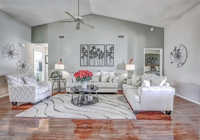 living room featuring hardwood / wood-style floors, ceiling fan, and high vaulted ceiling