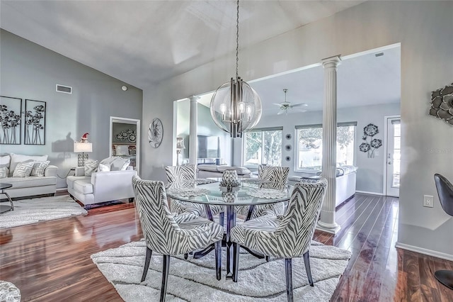 dining room with ceiling fan with notable chandelier, dark hardwood / wood-style flooring, and lofted ceiling