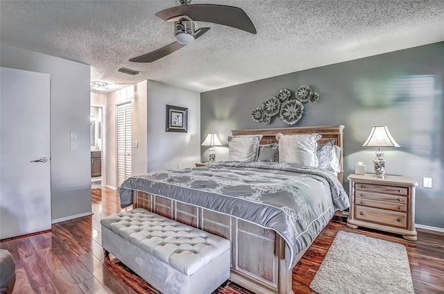 bedroom featuring a textured ceiling, dark hardwood / wood-style flooring, and ceiling fan