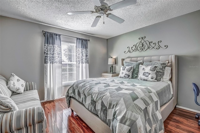 bedroom with a textured ceiling, dark hardwood / wood-style floors, and ceiling fan