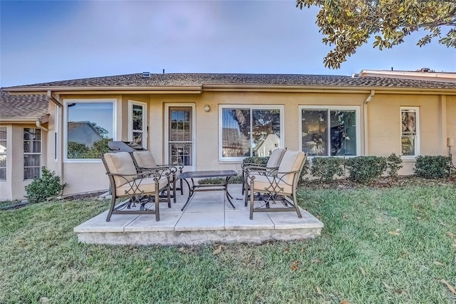 rear view of property with a lawn and a patio area