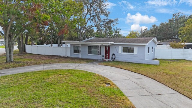 ranch-style home featuring a front yard