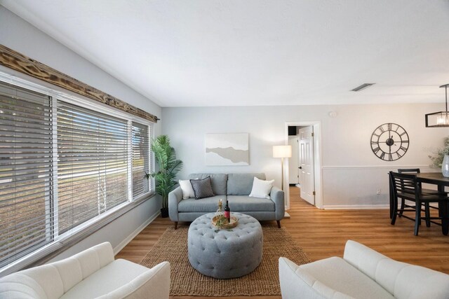 living room featuring hardwood / wood-style floors and an inviting chandelier