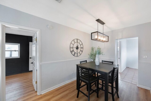 dining space with hardwood / wood-style flooring