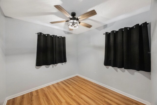 empty room featuring ceiling fan and wood-type flooring