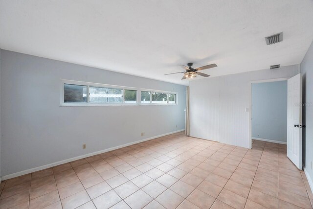 unfurnished room with ceiling fan and light tile patterned floors