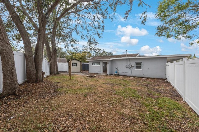 rear view of house with a storage unit